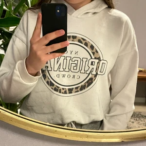 Vit hoodie med tryck - Vit hoodie med tryck och knytband längst ner, använd och ganska nopprig