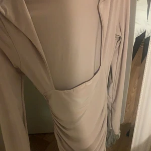 Boohoo minidress open back XS - En super snygg beige klänning från boohoo i storlek 34, den är i god skick och knappt använd. Ryggen är öppen på klänningen. Den är figursydd och får dina former att synas. 100+frakt. Pris kan diskuteras vid snabb affär!💕kan skicka tydligare bilder när ja har på mig klänningen vid förfrågan.🤍
