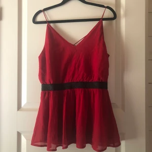 Röd blus - Röd blus med svart glitter i midjan från Vero Moda. Använd ett fåtal gånger. Första bilden är fram och andra bilden är bak. Strl M ❤️