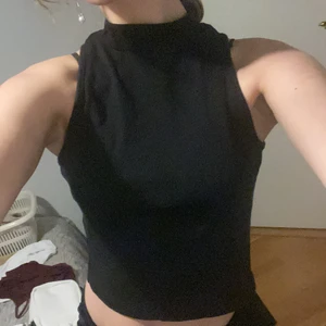 DIVIDED black sleeveless top - A great basic piece to have! Goes with a lot of things. Adds abit of class. Lovely stretchy material around the chest area. Overall fitting.