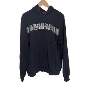 Burberry Sport hoodie - Säljer en snygg svart hoodie från Burberry Sport. Den har en cool silverfärgad logga på framsidan och är perfekt för både vardag och träning. Hoodien är i storlek L men funkar även för M . Passar perfekt för höst och vinter! Äkthetsgaranti finns 