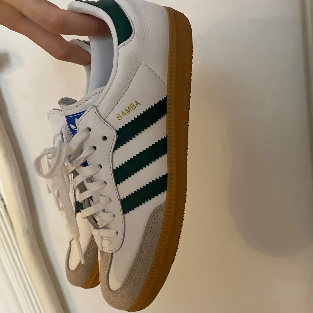 Säljer ett par adidas samba i vitt med gröna sträck (syns knappt på bilderna), storlek 38 2/3. Använda 2-3 gånger så de är i väldigt bra skick, säljs pga fel storlek. Skolådan medföljer.. Skor.