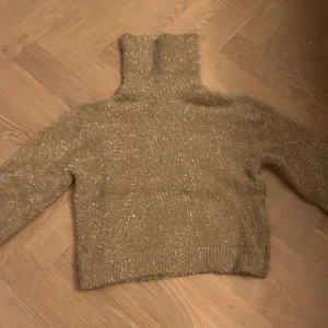 Glittrig polotröja - Den är super fin och gosig. Den har inte använts