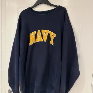 Vintage sweatshirt  - Vintage sweatshirt med trycket ”Navy” ifrån märket Steve & Barry’s. Tröjan är i gott skick. Köptes på secondhand butik. 
