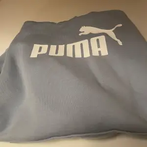 Säljer en snygg ljusblå hoodie från Puma i bra skick. Den har en stor logga på framsidan och en praktisk känguruficka. Perfekt för både vardag och träning. Huvan har dragsko för justering. Passar perfekt till höst,vinter och vår! Anväd 2-3 ☺️💗