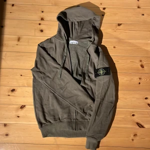 Grön hoodie från Stone Island - Säljer en snygg grön hoodie från Stone Island🐊Den har en dragkedja framtill och den klassiska loggan på ärmen🐉 Perfekt för höst, och den är även oanvänd🐲Den är i storlek M men sitter lite tajtare. Hör av dig vid frågor!🙏