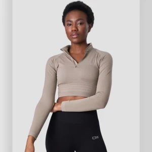 Beige croppad träningströja från ICANIWILL - Snygg beige croppad träningströja från ICANIWILL med dragkedja i halsen. Perfekt för gymmet eller löprundan. Tröjan har en tight passform och långa ärmar, vilket ger en stilren look. Superbekväm och funktionell för alla träningspass!