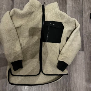 Beige fleecejacka från RevolutionRace - Mysig beige pile fleecejacka från RevolutionRace. Storlek XS. En fläck på armen, går säkert bort i tvätten har ej tid att tvätta. Nypris 899kr