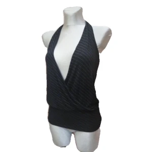 Super snygg ”Madona” topp 💋  - Snygg svart halterneck topp med vita ränder och djup v-ringning. Toppen har ett omlottmönster framtill och är perfekt för en stilren look. Passar bra till både jeans och kjol. Fråga gärna om information annars kör på köp nu!🌸💖(pasar också L) 