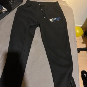 Svarta mjukisbyxor med broderad text - säljer ett par trapstar mjukisbyxor som är skit snygga och passar till massa olika tillfällen. Storlek L men passar även M