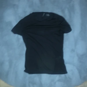 Svart t-shirt - Säljer en klassisk svart t-shirt med korta ärmar. Perfekt basplagg för alla tillfällen. Enkel och stilren design. Ganska genomskinlig