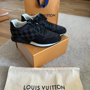  Louis Vuitton runners 43 - Snygga svarta sneakers från Louis Vuitton med ett klassiskt rutigt mönster. Skorna har snörning och en bekväm sula, perfekt för en stilren look. De kommer i originalförpackning med dustbag.