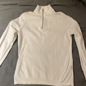 Vit tröja med dragkedja från Selected Homme - Säljer en stilren vit tröja från Selected Homme med halv dragkedja och ribbade detaljer. Perfekt för en avslappnad och snygg look. Kan gå ner i pris vid snabb affär!!