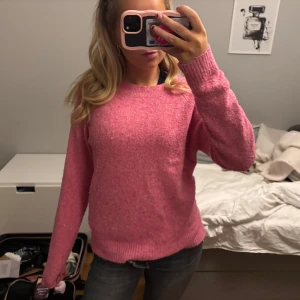 Rosa stickad tröja - Mysig rosa stickad tröja med rund hals och långa ärmar. Perfekt för kyligare dagar och ger en härlig färgklick till garderoben.