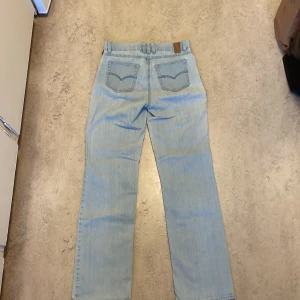 Jeans med glitter broderi på bakfickorna - Säljer ett par ljusblå jeans i storlek 36 från ROBELL jeans. Det har ett dekorativt mönster på bakfickorna och är i bra skick ⭐️