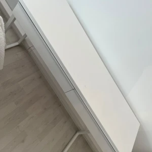 Vit modern byrå - Säljer en stilren vit byrå med två stora lådor. Perfekt för förvaring i sovrummet eller vardagsrummet. Den har en minimalistisk design med rena linjer och passar bra i moderna hem. Lådorna glider lätt och erbjuder gott om utrymme för prylar eller för att förvara smink. Toppen är slät och kan användas för dekorationer eller extra förvaring.