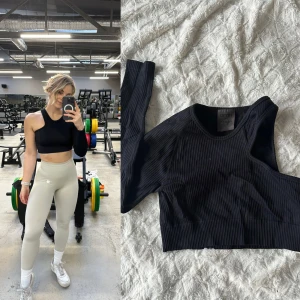 Svart ribbad croppad träningstopp - Snygg svart ribbad croppad träningstopp från Aimn. Storlek M.