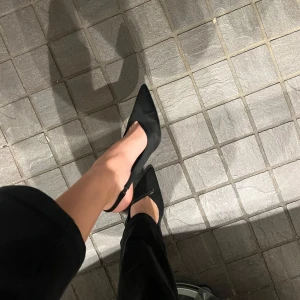 Svarta pumps med spetsig tå - Eleganta svarta pumps med spetsig tå och smal klack. Från stradivarius i storlek 39. Jag brukar ha mellan 38-39 och dessa sitter så bra! Klackhöjd: 8cm. Färgen på klacken har gått bort lite grann men inget som syns när man har på sig dem!🫶🏼