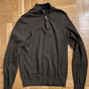 Brun tröja med dragkedja - Säljer en stilren brun tröja med dragkedja och ribbade muddar. Perfekt för kyligare dagar och passar bra till både jeans och chinos. Tröjan har en diskret logga på bröstet. Tröjan är M men sitter som ett S. Nypris 1800
