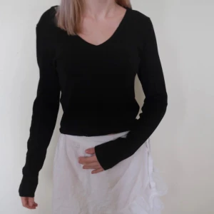 Svart långärmad tröja från Zara - Säljer en stilren svart långärmad tröja från Lager 157. Den har en v-ringad hals och är perfekt för både vardag och fest. Tröjan är i bra skick och passar till det mesta. Perfekt för höst och vinter!