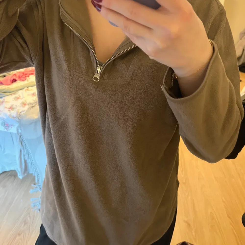 Säljer en brun fleece tröja med dragkedja framtill. Tröjan har långa ärmar och en bekväm passform.🤎. Neuletakit & Villapaidat.