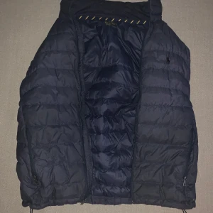 Mörkblå väst från Ralph Lauren MEDIUM - Säljer en snygg mörkblå dunjacka från Ralph Lauren. Använd några gånger men i mycket bra skick. Inga fel i den alls. DM om ni vill buda!