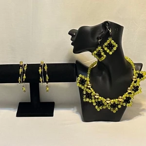 Set med halsband, armband och örhängen i pärlor - Unikt smyckeset med halsband, armband och örhängen i glittrande gula och svarta pärlor. Halsbandet har en elegant design med stora guldfärgade pärlor. Örhängena är fyrkantiga och matchar perfekt med resten av setet. Ett par örhängen och ett par armband plus en halsband handgjorda mycket mycket fint nytt oanvänd 