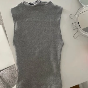 Grå ärmlös topp från Zara  - Snygg grå ärmlös topp i mjukt material.  Från Zara i storleken S