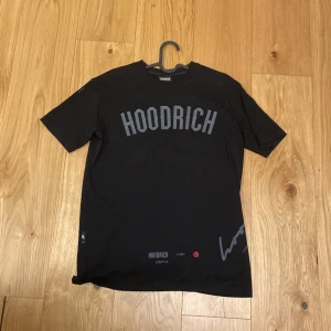 Svart t-shirt från Hoodrich - Snygg svart t-shirt från Hoodrich med tryck både fram och bak. Texten 'HOODRICH' pryder framsidan medan baksidan har texten 'FROM NOTHING TO SOMETHING'. Perfekt för en casual look. Den är storlek XS men sitter som S.