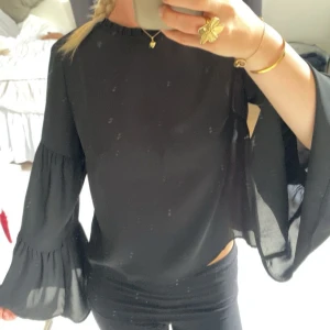 Svart blus med vida ärmar  - Säljer en svart blus från Gina som är lite genomskinlig och volang/vida ärmar💕