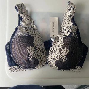 Mörkblå spets-bh från Intimissimi - Säljer en mörkblå bh från Intimissimi . Bh:n har justerbara axelband och elegant mönster framtill och baktill. Perfekt för dig som vill ha något både snyggt och bekvämt. Helt nya 