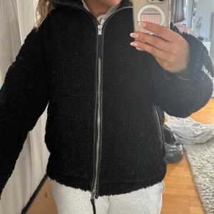 Svart teddyjacka med dragkedja - Populära teddy jackan från HM. Mysig svart teddyjacka med hög krage och hel dragkedja framtill. Bra skick!!💞