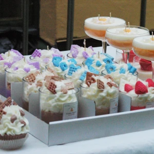 Ljus i glas och koppform - Säljer dekorativa ljus i glas och koppform, med detaljer som ser ut som chokladbitar, våfflor, jordgubbar och blommor. Finns i olika färger som vitt, blått, lila och rött. Perfekt som present 