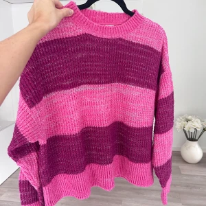 Randig rosa stickad tröja - Superfin stickad tröja från Kappahl i storlek M. Tröjan har breda ränder i rosa och lila, med ribbade muddar och avslappnad passform. Perfekt för dig som gillar färg och vill ha en mysig vibe i garderoben. 🩷💜 Önskar du veta exakta mått? Tveka inte att höra av dig!