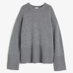 Grå stickad tröja - Säljer en mysig grå stickad tröja med rund hals och långa ärmar. Tröjan har en ribbad nederkant! 