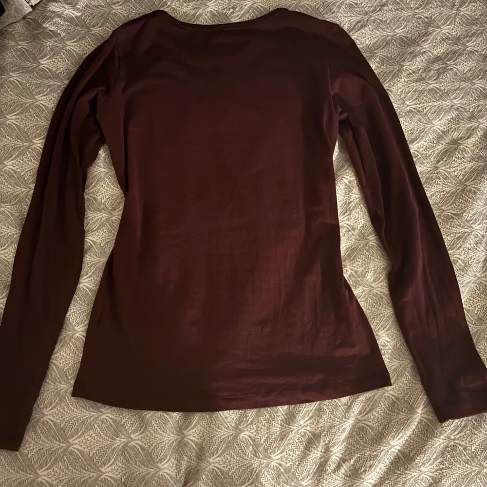 Säljer en stilren vinröd långärmad topp från Cubus. Perfekt för kyligare dagar med sin mjuka och bekväma passform. Enkelt att matcha med olika outfits. Hör av dig vid intresse! 💌 Denna tröja är i XS men jag skulle säga att den är S.. Neuletakit & Villapaidat.