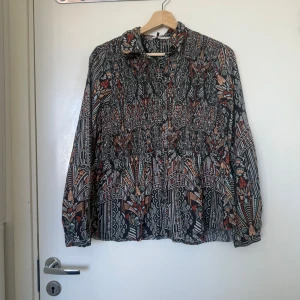 Odd molly skjorta  - Otroligt vacker svart skjorta med massa olika färger i ett väldigt fint mönster. Från märket Odd Molly i storlek 1 som ungefär motsvarar en storlek S. Mycket fint skick, jag hittar inga synlig anmärkningar eller defekter. 