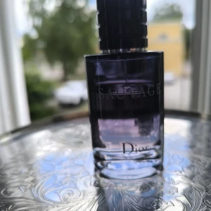 Dior Sauvage Eau de Toilette 60ml - Dior Sauvage Eau de Toilette i en stilren, mörkblå glasflaska med silverdetaljer och svart kork. Flaskan rymmer 60 ml och har en modern, maskulin design med tydlig Dior-logga och Sauvage-tryck. Perfekt för dig som gillar fräscha och kryddiga dofter. Se bild och avgör mängd kvar 