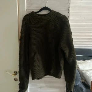 Grön stickad tröja med knytning - Så snygg stickad med knytningar på ärmarna