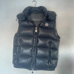 Moncler Maya väst - Nästan helt ny Moncler Maya väst! Använd ett fåtal gånger, bilderna kan se lite konstiga ut för min galje får västen att hänga lite snett. (Pris kan diskuteras)