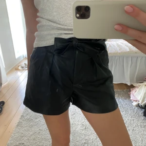 Svarta läder shorts - Läder shorta med rosett