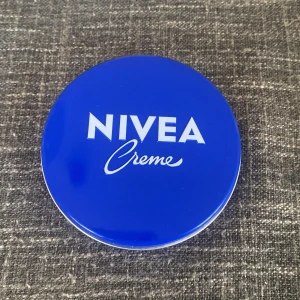 NIVEA Creme burk - Klassisk blå plåtburk med NIVEA Creme, en vit och rik ansiktskräm. Perfekt för återfuktning av huden, passar både till ansikte och kropp. Burken är rund och smidig att ta med i väskan. ANDVÄND ETT FÅTAL GÅNGER