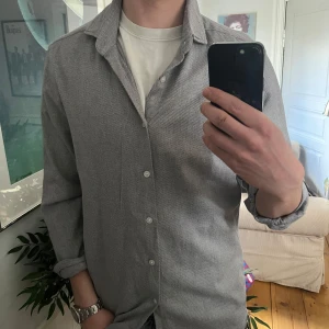 Grå skjorta från Massimo Dutti - Snygg grå skjorta från Massimo Dutti. skjortan oanvänd och i toppskick.