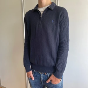 Half zip från Polo Ralph Lauren - Säljer denna mörkblå stickade tröja från Polo Ralph Lauren! Tröjan är gjord av Pima-bomull vilket gör den extra skön!  Den är i fint skick och har inga större defekter! Modellen är ca 180cm. Tveka inte på att höra av dig om du har frågor!🙌Priset är inte hugget i sten! 🪨 