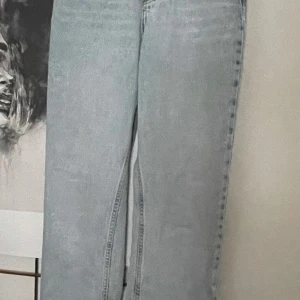 Ljusblå straight split jeans 25/30 - Snygga ljusblå jeans från Bikbok med raka ben och slits nertill. Klassisk femficksmodell i denim med dragkedja och knapp framtill. 