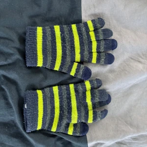 Randiga stickade fingervantar - Stickade fingervantar med mörkblå och neongula ränder. Perfekta för kyliga dagar och ger en färgglad touch till din outfit. Mjuka och stretchiga för bra passform.