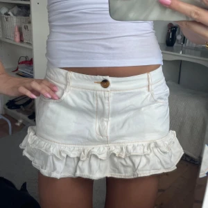 Jeans kjol med volang  - Vit jeans kjol med snygga volang detaljer! Aldrig använd. Storlek M men passar både S och M