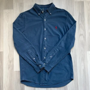 Blå overshirt Ralph Lauren - Snygg blå overshirt från Ralph Lauren med klassisk krage och knappar hela vägen. Broderad röd logga på bröstet. Kontakta för exakta mått fler bilder eller funderingar😇.    pris går att diskutera 