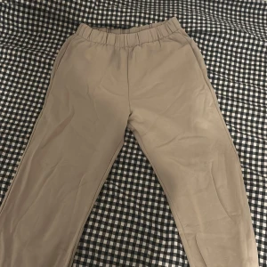 Beige mjukisbyxor från H&M Divided - Säljer ett par bekväma beige mjukisbyxor från H&M Divided. Byxorna har en elastisk midja för extra komfort och är perfekta för en avslappnad stil. Tillverkade i mjukt material som ger en skön känsla hela dagen.