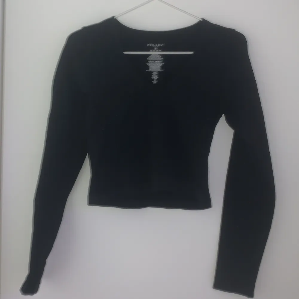 Säljer en stilren svart långärmad topp från Primark. Perfekt för en enkel och elegant look. Toppen har en normal passform och är tillverkad i ett mjukt material.. Neuletakit & Villapaidat.